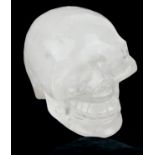 A LARGE ROCK CRYSTAL CARVED AS THE FORM OF A HUMAN SKULL. (w 10cm x d 13cm x h 10cm)