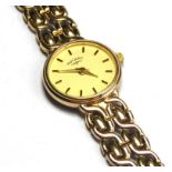 ROTARY, A 9CT GOLD LADIES' WRISTWATCH Having a cream tone dial and integral gold bracelet strap. (