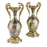 A PAIR OF 19TH CENTURY FRENCH PORCELAIN AND BRONZE ORMOLU VASES Having hand painted oval panels on