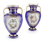 ATTRIBUTED TO BACCARAT, A PAIR OF BLUE GROUND OPALINE GLASS VASES Twin gilt handles with hand