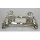 A VICTORIAN SILVER SCROLLED RECTANGULAR INKSTAND Georgian design, set with two glass inkwells and