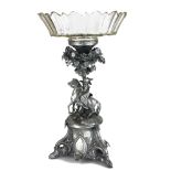 A 19TH CENTURY WHITE METAL AND LEAD CRYSTAL FIGURAL CENTREPIECE The faceted circular glass bowl
