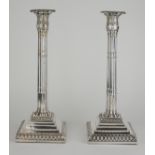 A PAIR OF GEORGIAN SILVER CANDLESTICKS Classical form with bamboo design column supports on a