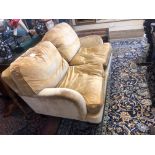 A 20TH CENTURY HOWARD DESIGN TWO SEAT SOFA Mustard velvet upholstery, with feather filled loose