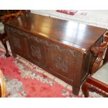 A 17TH CENTURY DESIGN CARVED OAK THREE PANELLED COFFER, EARLY 20TH CENTURY. (129cm x 53cm x 65cm)