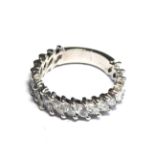 AN 18CT WHITE GOLD AND DIAMOND HALF ETERNITY RING Having an arrangement of nineteen trillion cut