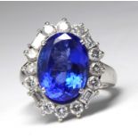 A LARGE AND IMPRESSIVE 14CT WHITE GOLD TANZANITE AND DIAMOND RING Having a central oval cut