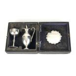 A CASED VICTORIAN SILVER COMMUNION SET Having a miniature ewer, chalice and plate, hallmarked George
