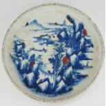 A CHINESE BLUE AND WHITE POTTERY SHALLOW BOWL Hand painted in underglaze blue and iron red,