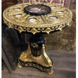A 20TH CENTURY EMPIRE DESIGN GILT BRONZE AND EBONISED CENTRE TABE The embossed circular top inset