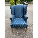 A GEORGIAN STYLE WING ARMCHAIR Along with a Lloyd Loom chair and two Edwardian dining chairs.