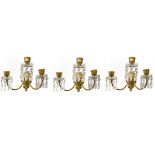 BACCARAT, A SET OF THREE CRYSTAL AND GILT BRONZE THREE BRANCH WALL SCONCES Classical form, hung with