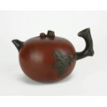 A CHINESE XING XING TERRACOTTA TEAPOT Organic form with gnarled branch handle and square character