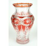 A LARGE 20TH CENTURY BOHEMIAN GLASS VASE Having orange overlay and floral form cuts. (approx 36cm)