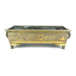 A CHINESE BRONZE RECTANGUAR PLANTER With raised decoration on trellis, bearing four character mark