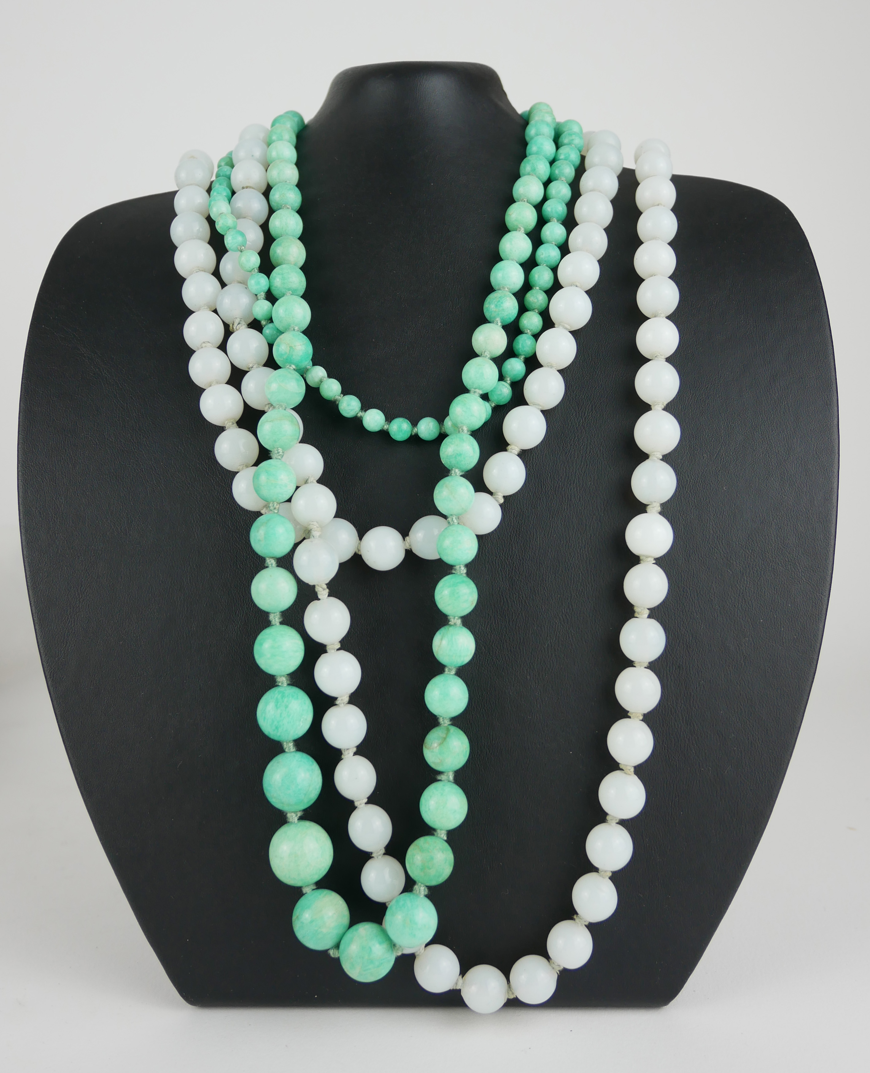 TWO VINTAGE HARDSTONE NECKLACES Comprising a single strand of spherical beads and a strand of