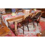 A SOLID YEW WOOD REFECTORY TABLE With four planks above a carved apron, raised on canon barrel