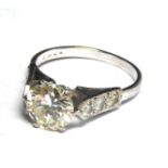 AN 18CT WHITE GOLD AND 2.5CT DIAMOND RING The single round cut diamond flanked by diamond set