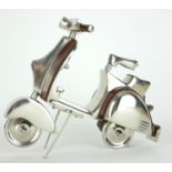 A CHROME AND LEATHER DESKTOP MODEL OF A VESPA SCOOTER. (28cm x 20cm)