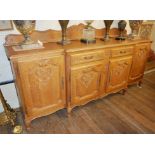 AN EARLY/MID 20TH CENTURY DUTCH OAK BREAKFRONT SIDEBOARD With an arrangement of two drawers and
