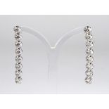 A PAIR OF 18CT WHITE GOLD AND DIAMOND DROP EARRINGS Each earring having a single line of eight round