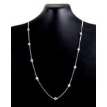 AN 18CT WHITE GOLD AND DIAMOND NECKLACE Line of ten round cut diamonds on a fine link gold chain. (