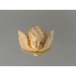A VICTORIAN CARVED IVORY CHERUB BROOCH Gilt metal brooch fitting, boxed. ()