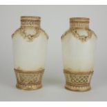 A PAIR OF EARLY 20TH CENTURY FRENCH BALUSTER PORCELAIN VASES With embossed floral decoration and