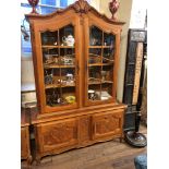 AN EARLY MID 20TH CENTURY DUTCH OAK BOOKCASE/DISPLAY CABINET The shaped pediment centred with a