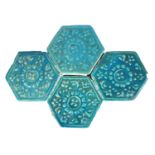 A SET OF FOUR 14TH CENTURY KASHAN TURQUOISE HEXAGONAL TILES With relief floral decoration. (each