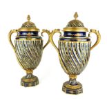 A PAIR OF 19TH CENTURY SEVRES PORCELAIN AND ORMOLU URN FORM COVERED VASES Twin ormolu handles and