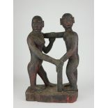 AN EAST ASIAN CARVED WOODEN FIGURAL GROUP Courting couple in tribal attire. (approx 45cm)