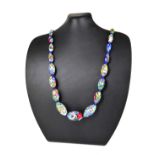 A VINTAGE ITALIAN GLASS MILLEFIORRI NECKLACE The single strand of multicoloured graduated glass