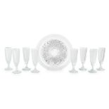 ATTRIBUTED TO BACCARAT, A SET OF EIGHT HOBNAIL CUT CHAMPAGNE FLUTES On circular tray.