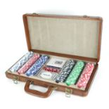 A TRAVELLING POKER SET In brown leather fitted carrying case to include two decks of playing cards