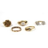 A COLLECTION OF FIVE VINTAGE 9ct GOLD AND PASTE SET RINGS Comprising an unusual horseshoe ring, an