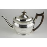 A GEORGE III CLASSICAL FORM SILVER OVAL TEAPOT With carved wooden finial and handle, finely engraved