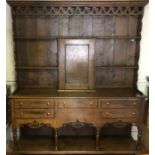 A VICTORIAN STYLE OAK DRESSER With pierced fretwork gallery above open shelves with central