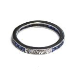 AN ART DECO PLATINUM, SAPPHIRE AND DIAMOND ETERNITY RING Set with rows of four baguette cut