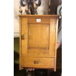 ARTS & CRAFTS, AN OAK WALL MOUNTING MEDICINE CABINET With a single panel door above drawer.