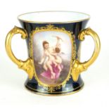 A 19TH CENTURY ROYAL VIENNA THREE HANDLED TIG With gilded borders enclosing romantic hand painted