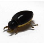 A VINTAGE YELLOW METAL AND BAKELITE BEETLE BROOCH Beige Bakelite body with yellow metal frame,