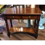 A VICTORIAN MAHOGANY SIDE TABLE With two drawers and lower shelves, on turned legs. (90cm x 43cm x