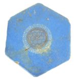 A 12TH CENTURY PERSIAN BLUE GLAZE CERAMIC HEXAGONAL TILE With scrolled painted cartouche to