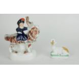 A 19TH CENTURY STAFFORDSHIRE POTTERY FIGURE, A YOUNG GIRL RIDING A GOAT Together with a recumbent