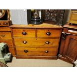 A VICTORIAN PINE CHEST With two short above two long drawers fitted with brass cup handles, on