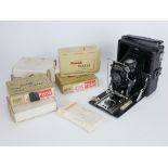TRICHRO, AN EARLY 20TH CENTURY PLATE CAMERA AND GLASS SLIDES Having black fabric bellows and