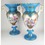 A PAIR OF SÈVRES STYLE TWIN HANDLED VASES With gilded decoration and two panels decorated with