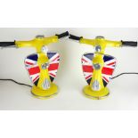 A PAIR OF DECORATIVE TABLE LAMPS IN THE FORM AS THE FRONT SECTION OF A VESPA SCOOTER, YELLOW. (33cm)