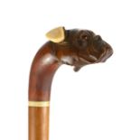 A 19TH CENTURY CARVED TREEN AND IVORY ARTICULATED DOG FORM WALKING STICK The carved head having